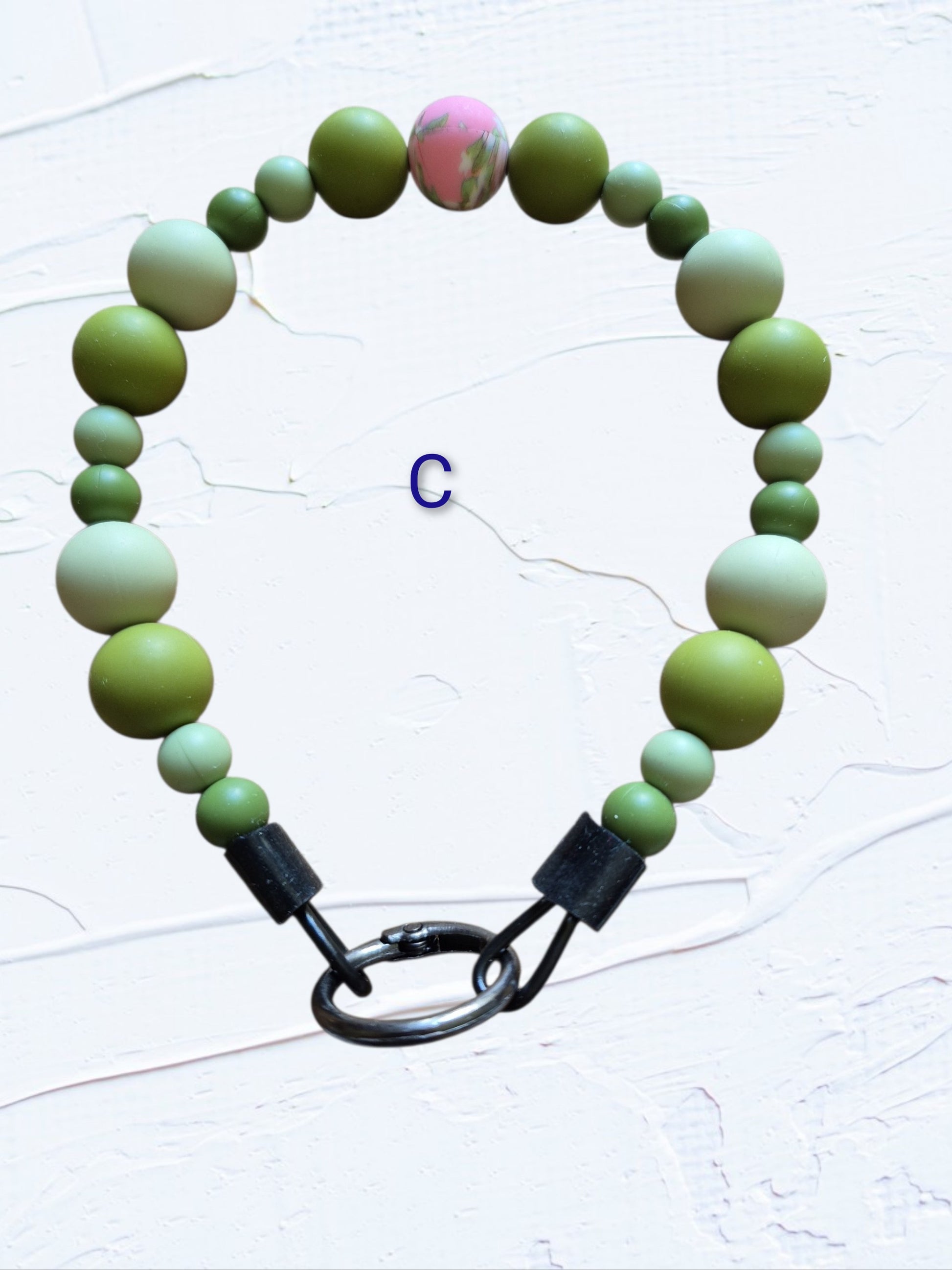 olive and sage green beads with a pink marbled accent bead