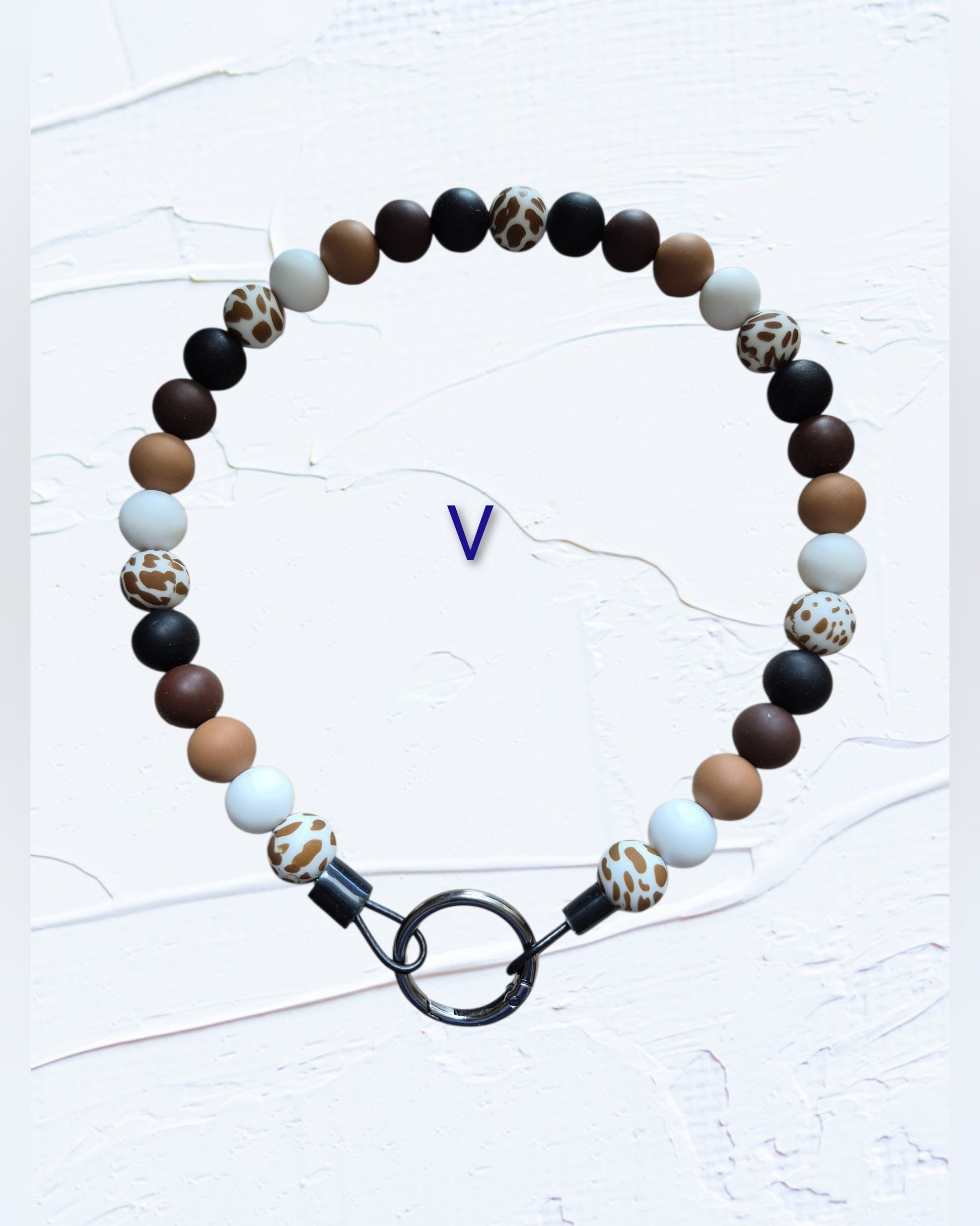 black, brown, tan, white and leopard print accent beads with black O-ring clasp