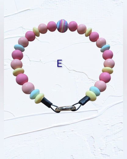 pink and pale yellow beads with a multicolour striped accent bead