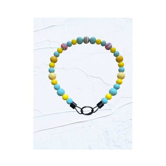  teal, yellow and cream beads with multicolour swirl accent bead and black O-ring clasp
